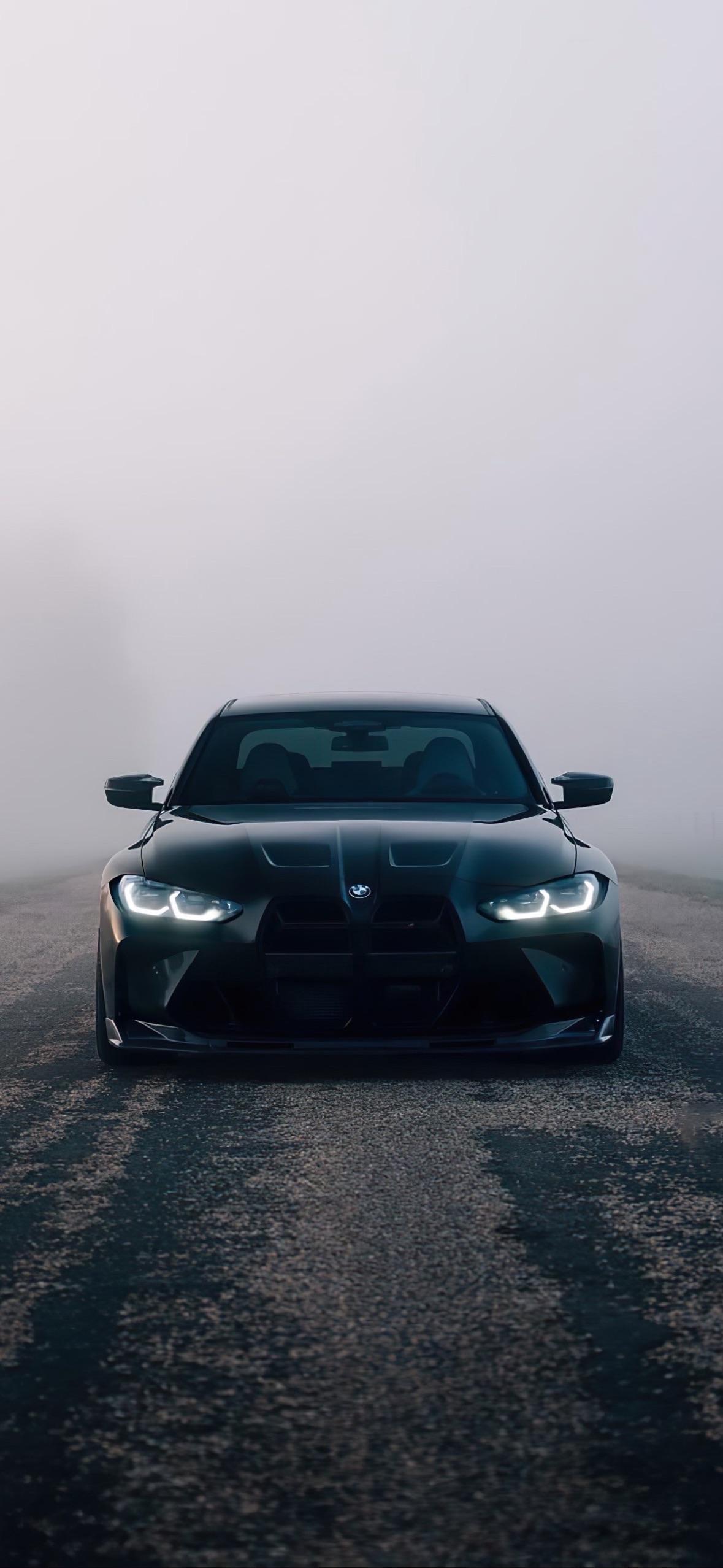 Sleek Black Bmw on a Foggy Road