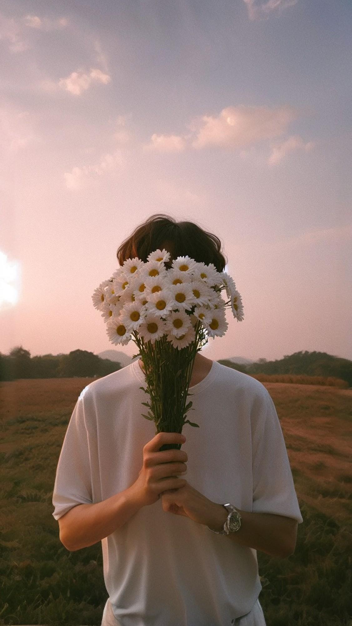 Sad Boy Aesthetic Face Behind a Daisy Bouquet Wallpaper