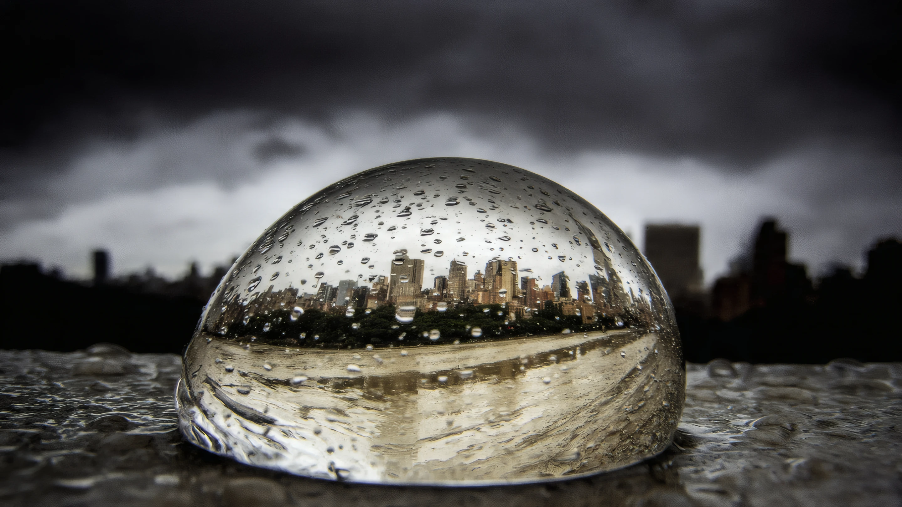 City Skyline Reflected in Raindrop on Overcast Day Wallpaper