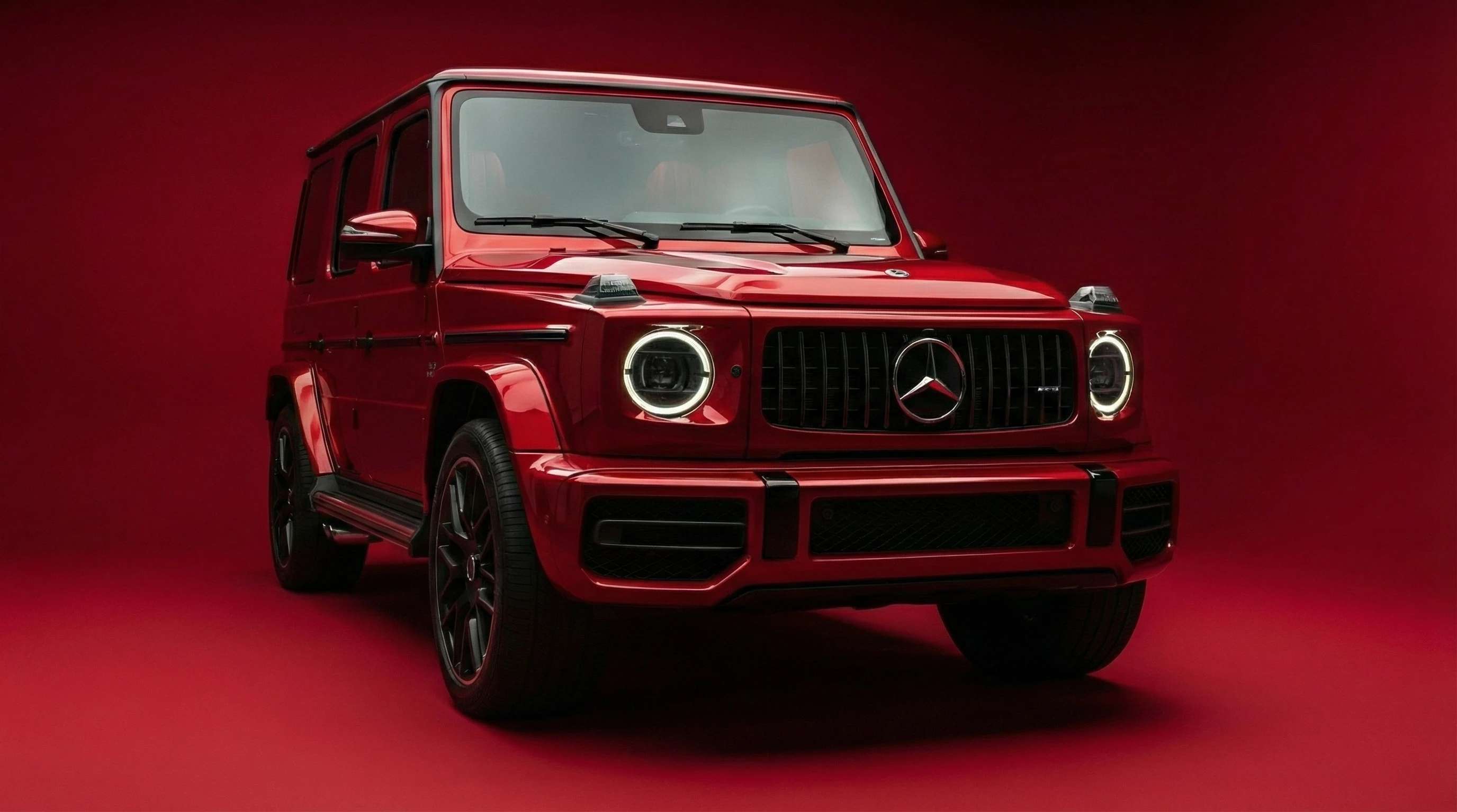 Crimson Mercedes G-wagon on Red Backdrop