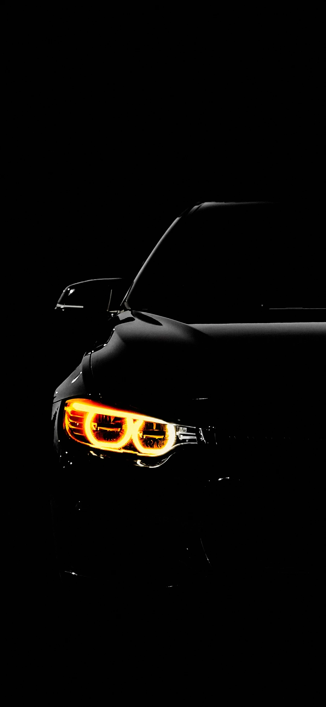 Sleek Black Car with Glowing Orange Headlights