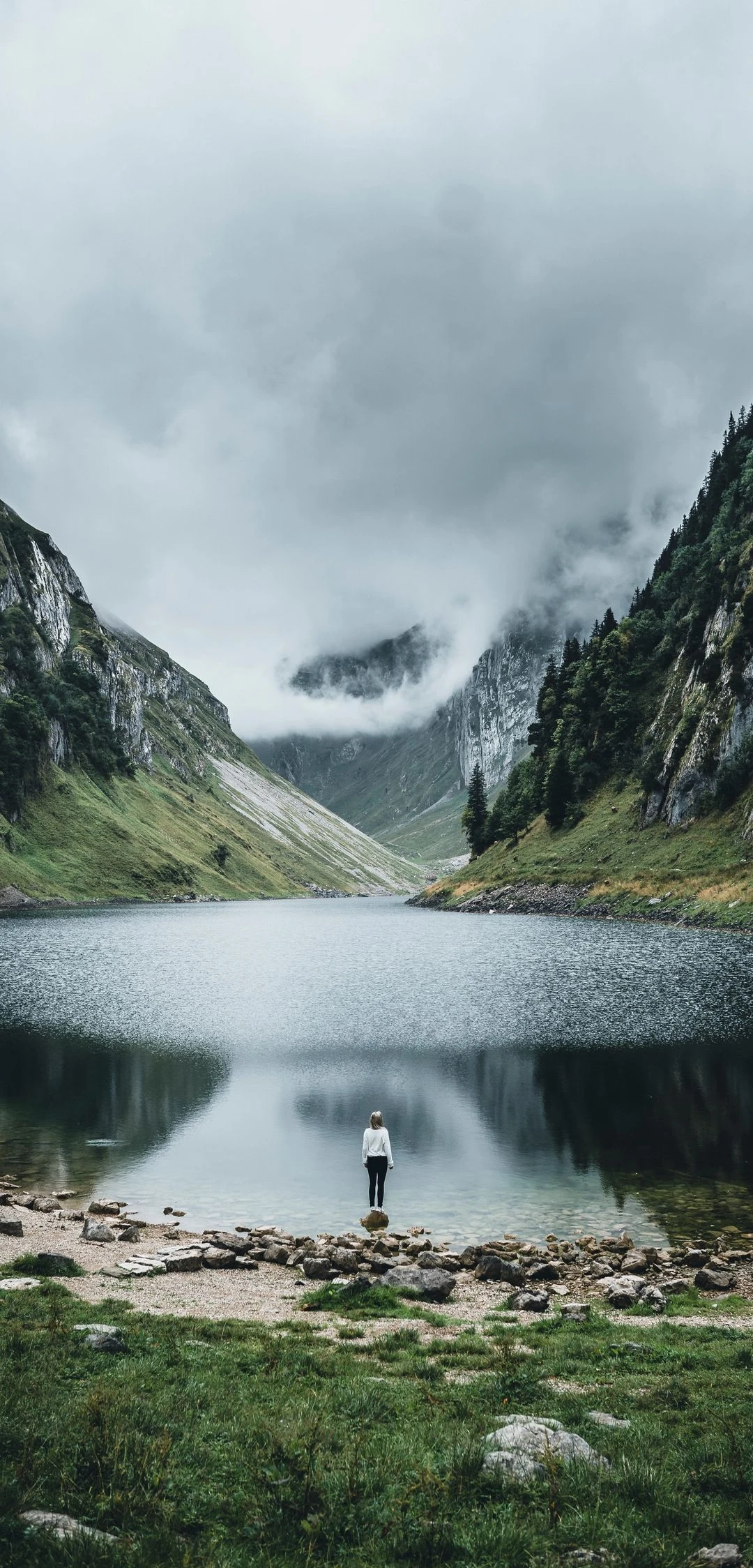 Solitary Figure at Misty Alpine Lake Reflection